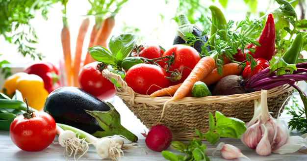 Vegetables across a counter in the sunlight